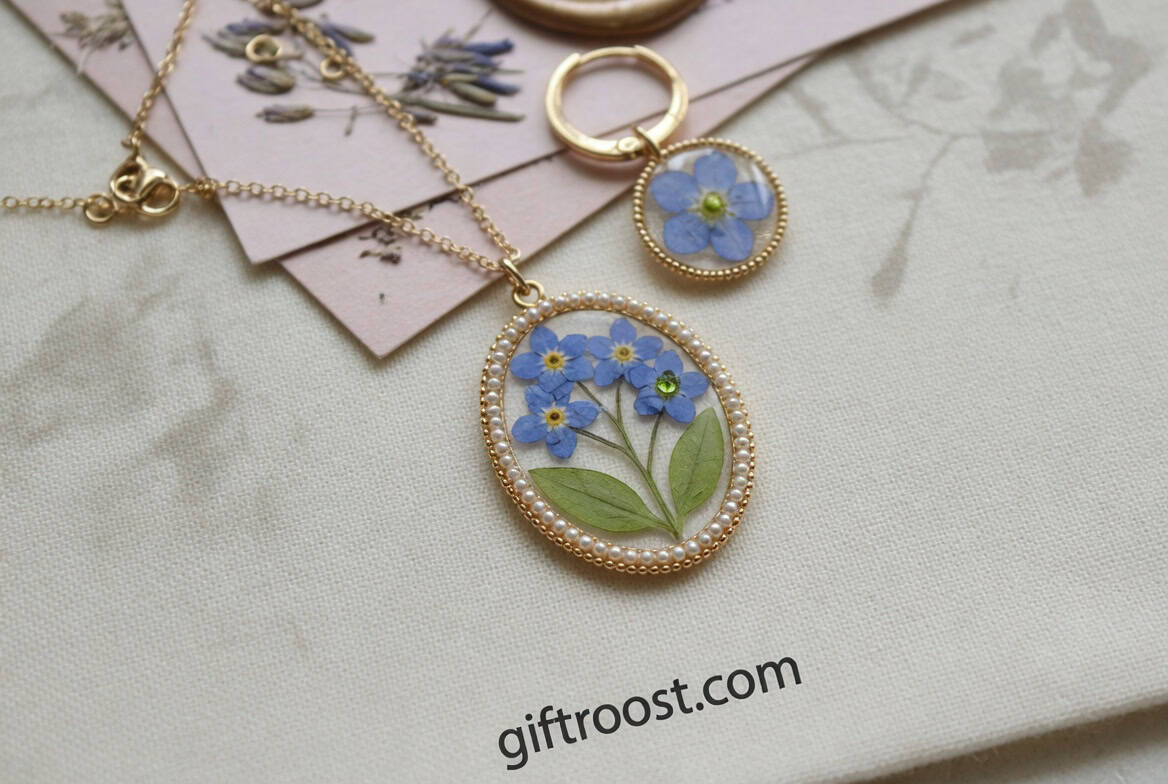 Elegant blue flower jewelry pendant with gold chain, perfect Mother's Day gift idea.